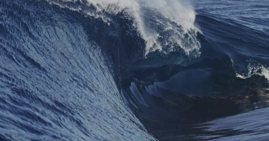 Waves crashing into the sea on a sunny day