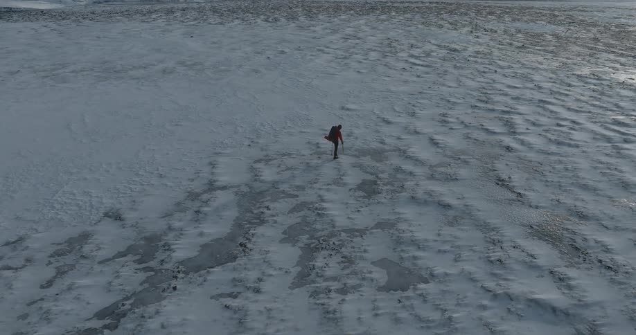 Man walking on an icecovered mountain