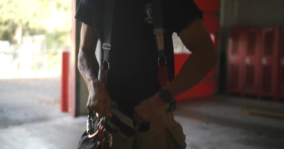 Firefighter putting on his protective gear