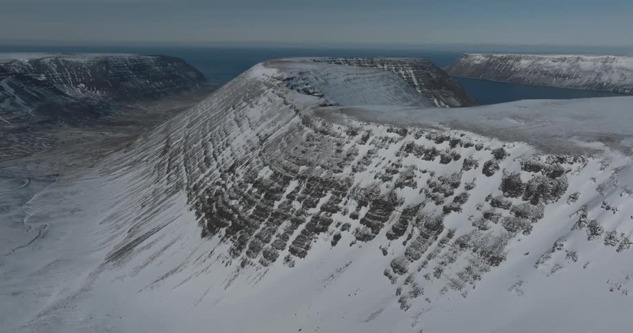 Aerial view of icecovered mountains with a lake in the background