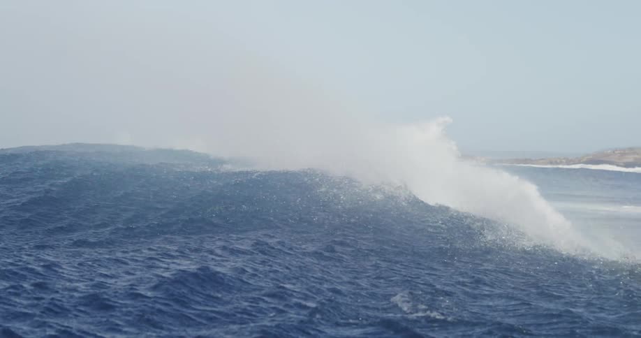 Sea with furious waves breaking on the shore of the beach