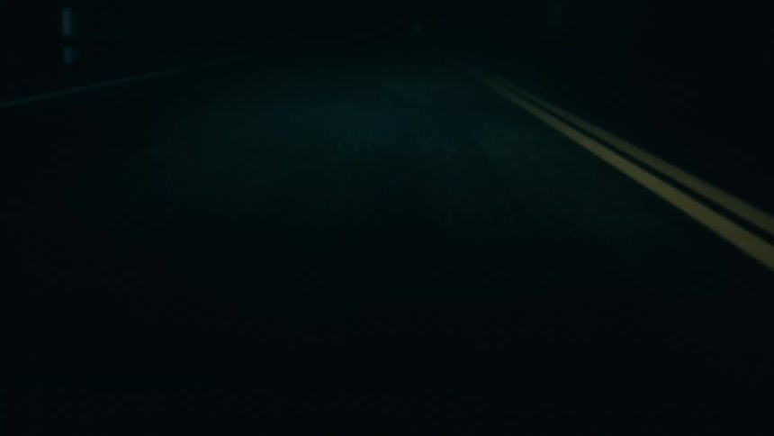 Close up of a road at night in motion