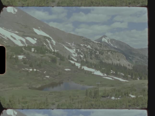 Lake next to a mountain range caught on vintage film