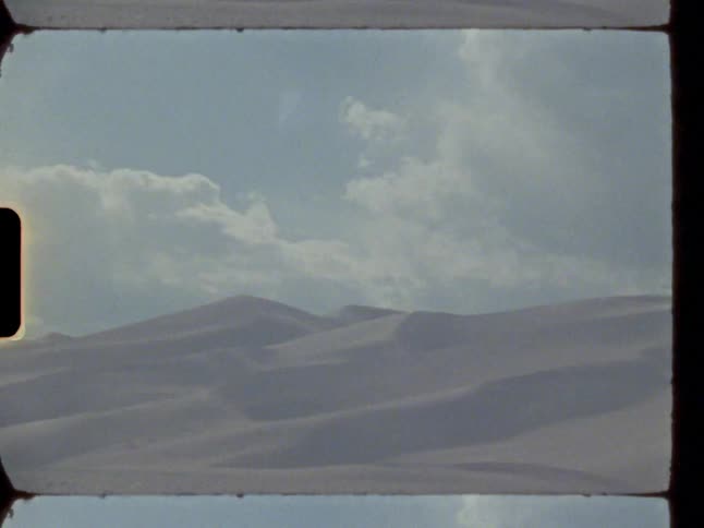 Clouds cast shadows across arid landscape