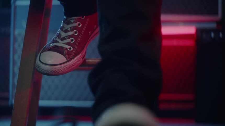 A person taps his feet to the music