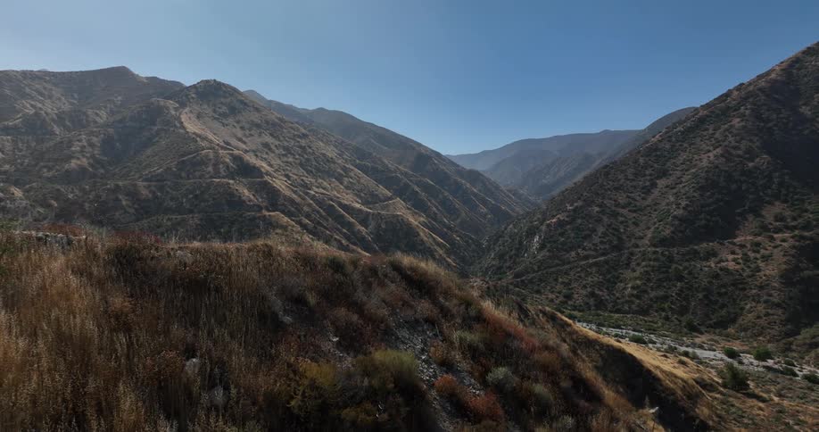 Mountain range and cliffs covered in vegetation in natural daylight