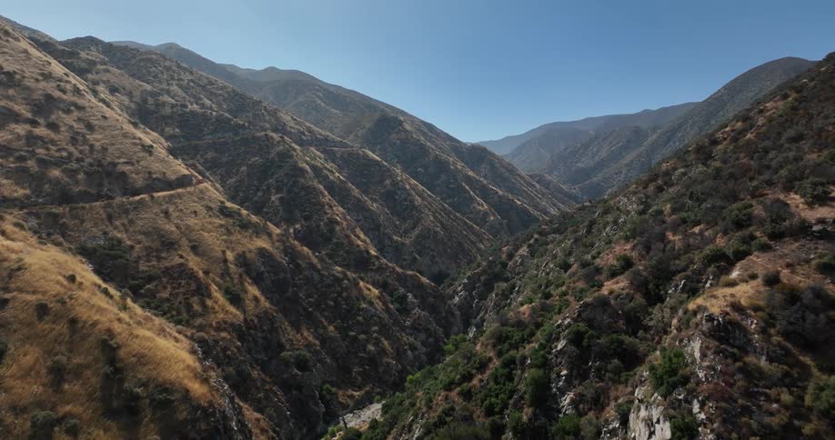 Aerial of large mountain ranges with deep valleys and ridges across the landscape