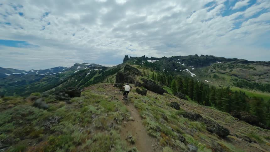 Aerial of a mountain biker on a dangerous adventure