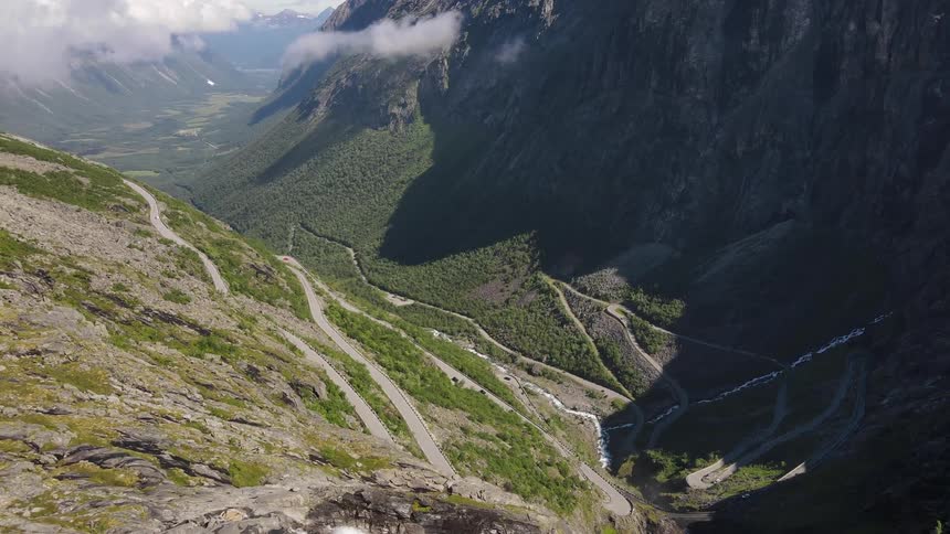 A rocky mountain stream with dangerous roads in the landscape