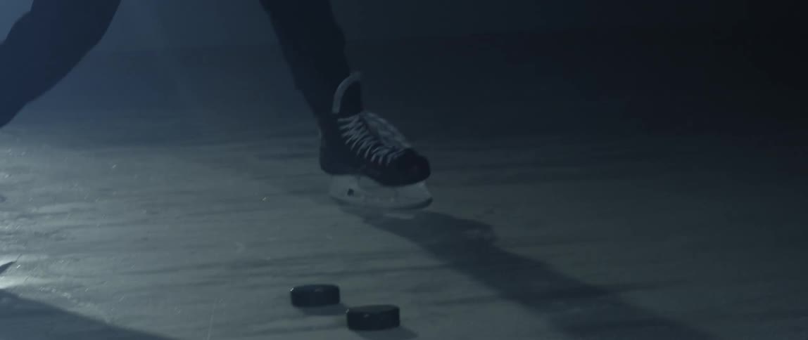 A person playing hockey on an ice rink