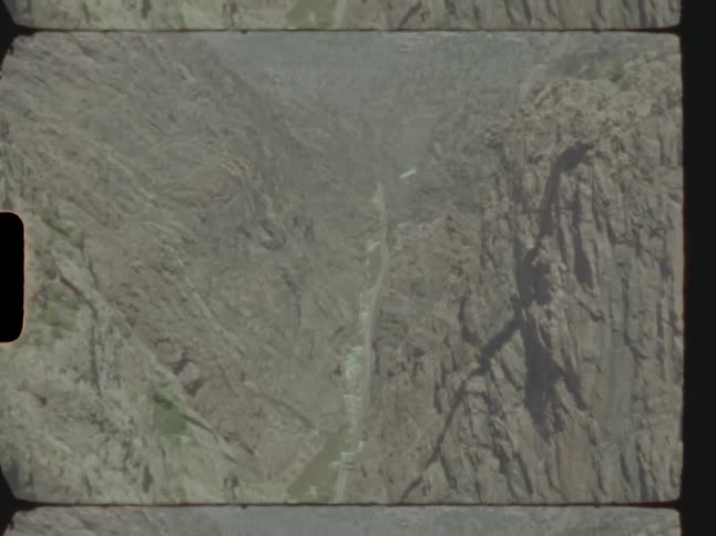 Fog covers terrain including river flowing along rugged slope