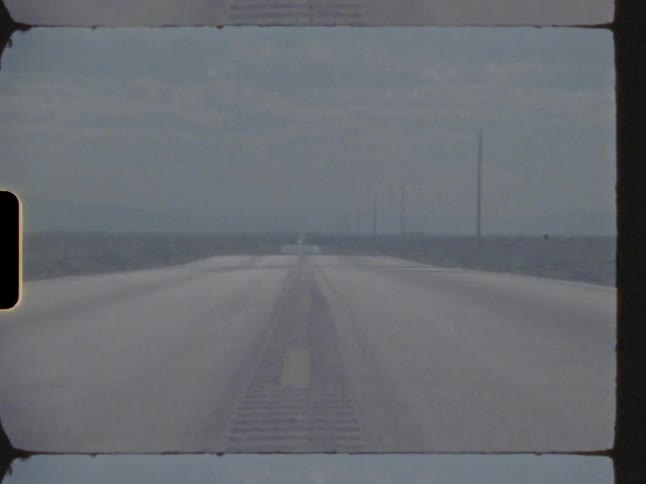 Vehicle sits on road on hazy cloudy day