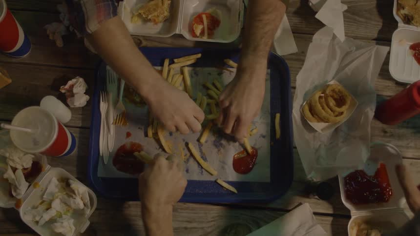 People are eating food together at a table