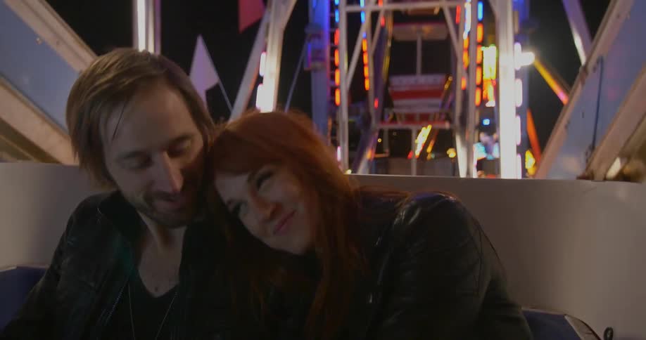 Couple riding a ferris wheel