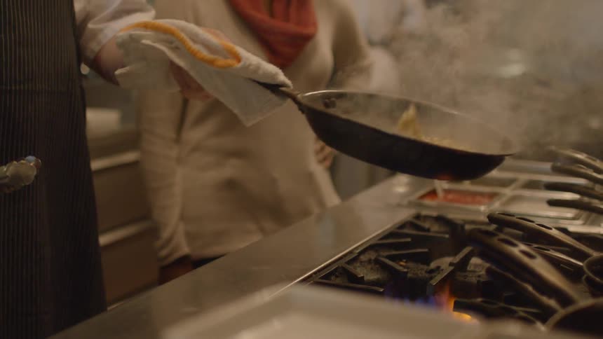A chef is cooking in a kitchen