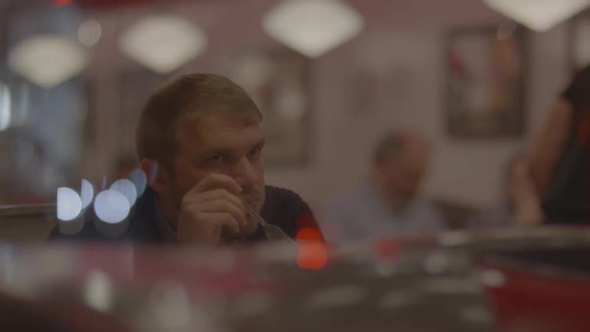 A man is eating in a restaurant