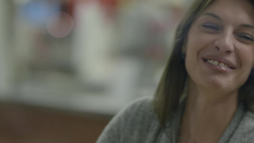 A woman is talking and eating