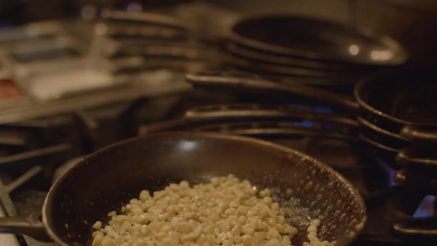 A person flips food in a pan
