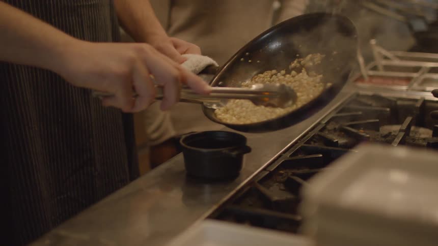 A person is cooking in a large kitchen