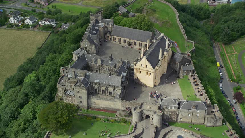 Aerial view of an ancient castle on a hill next to town