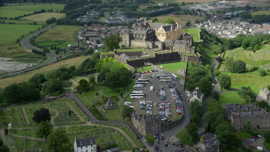 Aerial of a suburban neighborhood with a castle in the mountains