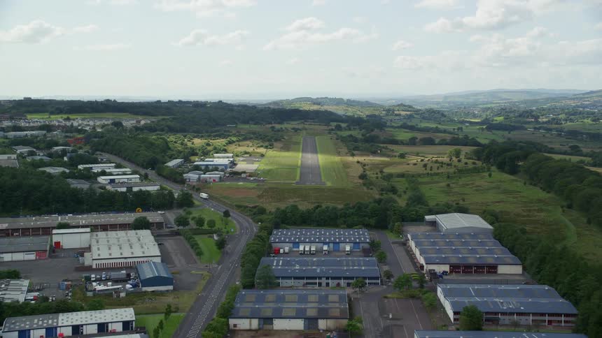 Aerial of a rural city with factories and an airstrip
