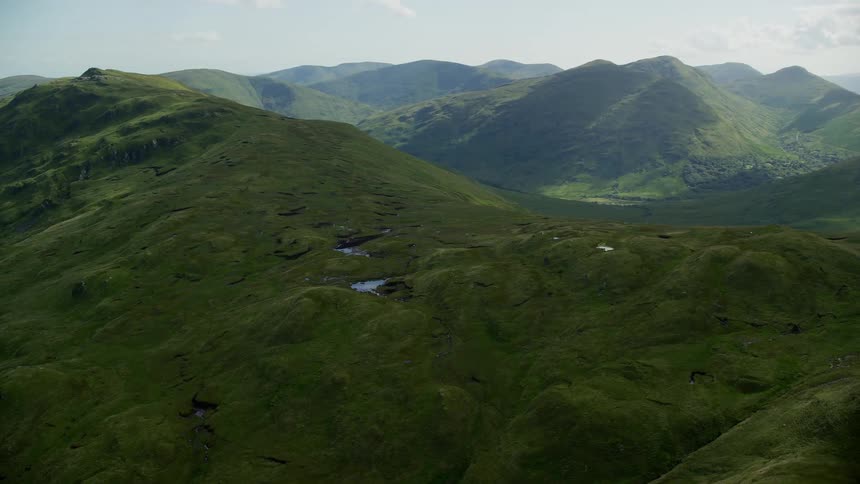 Aerial of a verdant mountain with a cloudy sky