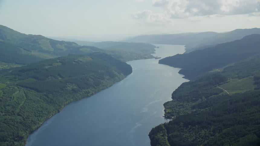 Aerial view of a large river between mountains at daytime