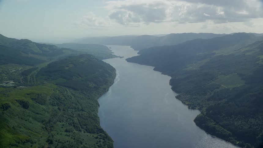 Aerial view of a large river between mountains at morning