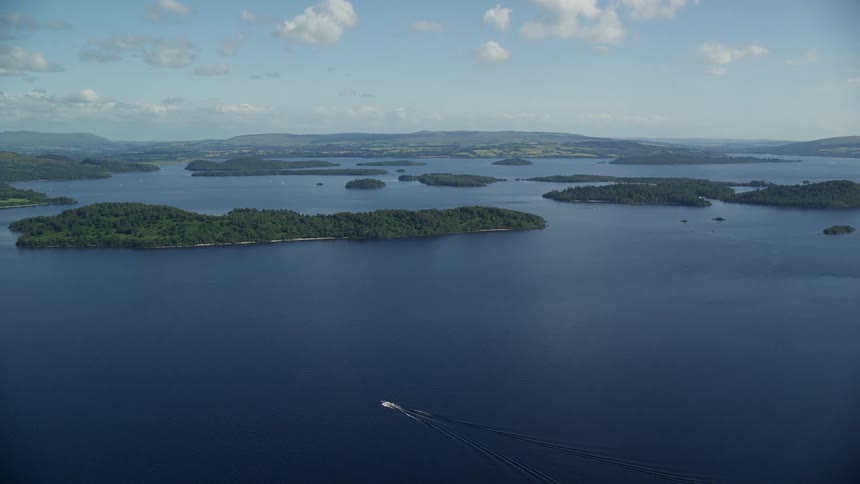 Aerial view of a sea with small islands and mountains on the horizon