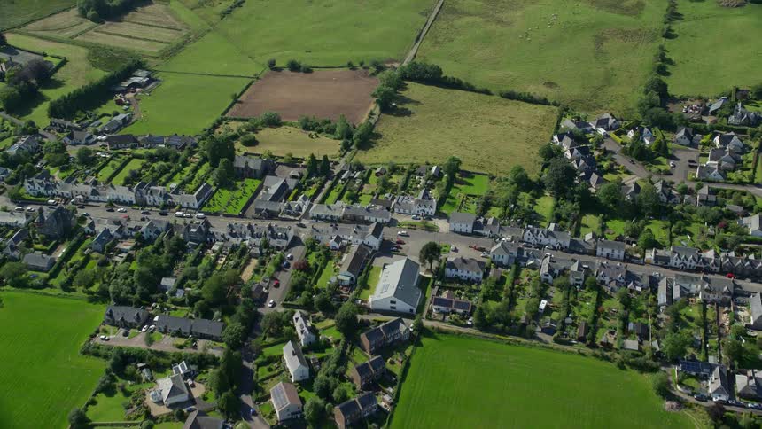 Aerial view of rural neighborhood and farmland