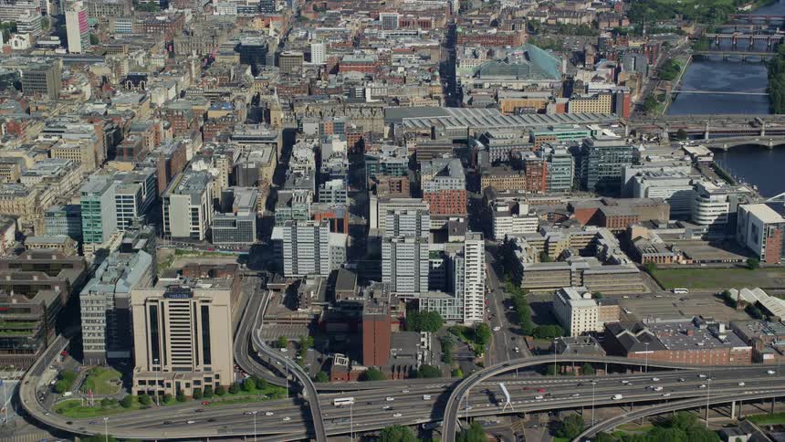 Vehicles drive along a highway running through downtown