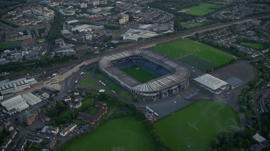 A football stadium is set apart from dense neighborhoods in a suburb