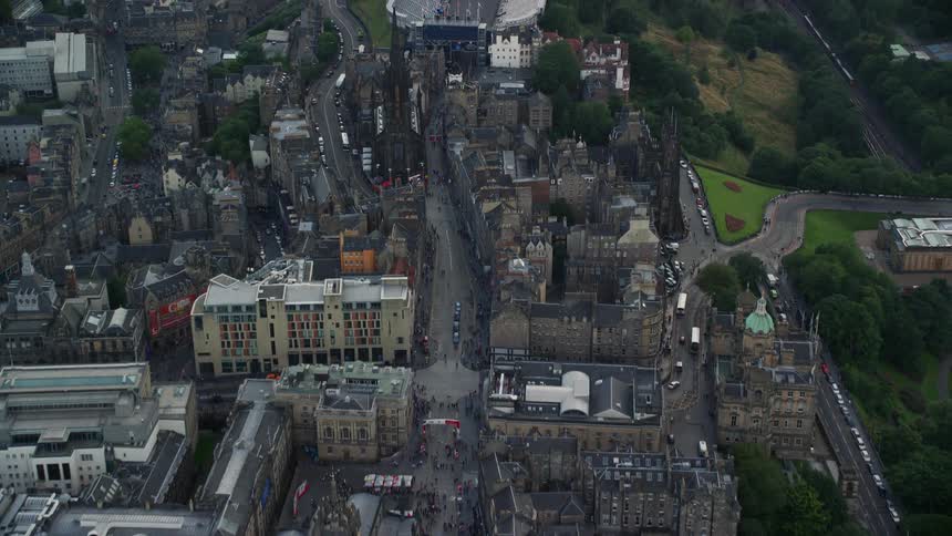 Aerial of a city with architectural buildings and streets filled with cars during the day