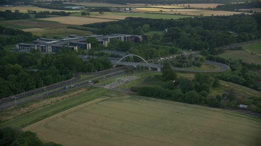 Aerial view of agricultural fields and highways with cars moving