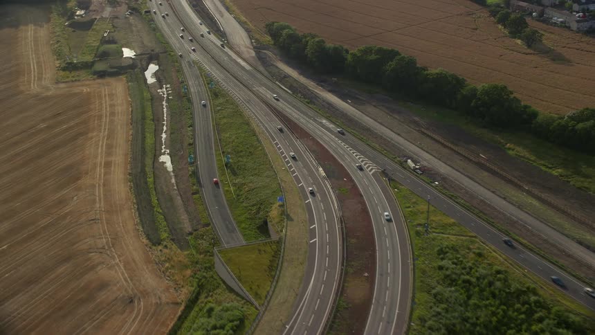 Aerial view of cars driving on a highway through the countryside