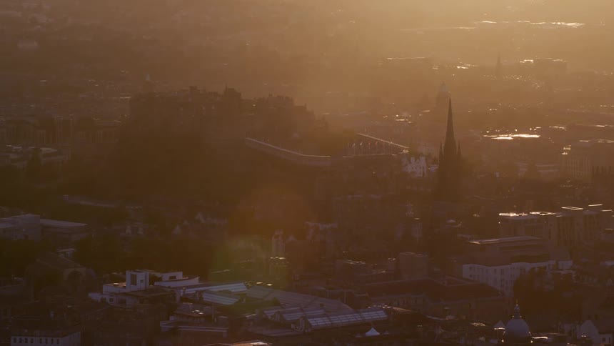 Aerial view of city center and spires at golden hour