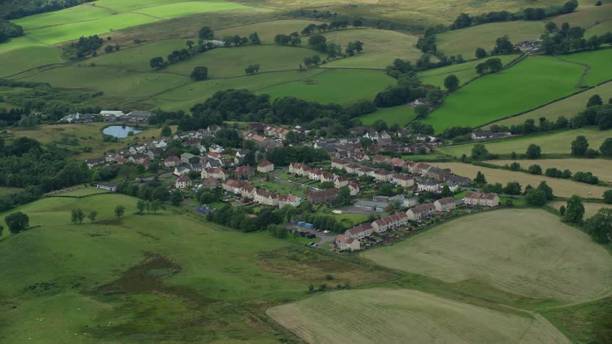 A neighborhood is surrounded on all sides by open fields