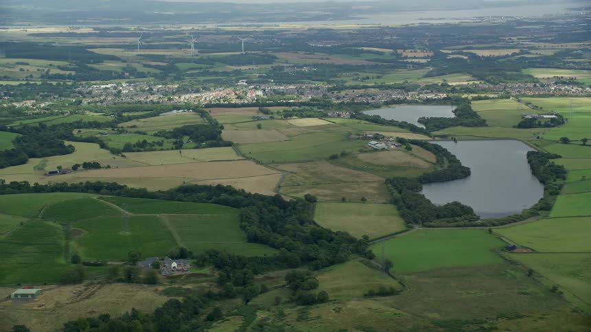 Aerial view of a small town in the middle of fields and lakes