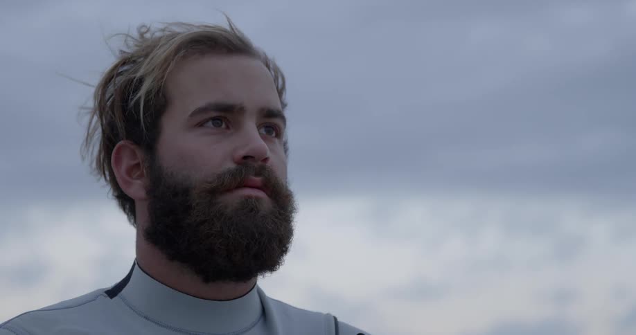 Bearded man outside on a cloudy day