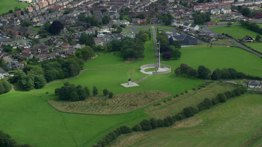 Suburban homes sit close together near vast open fields