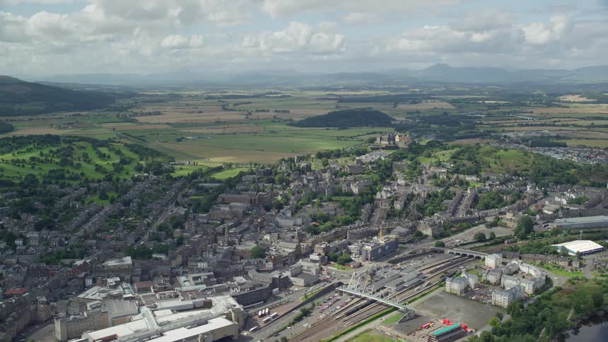 Aerial view of a city surrounded by vegetation and mountains