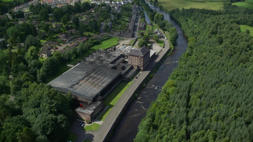 Aerial of a rural neighborhood with small houses and a river
