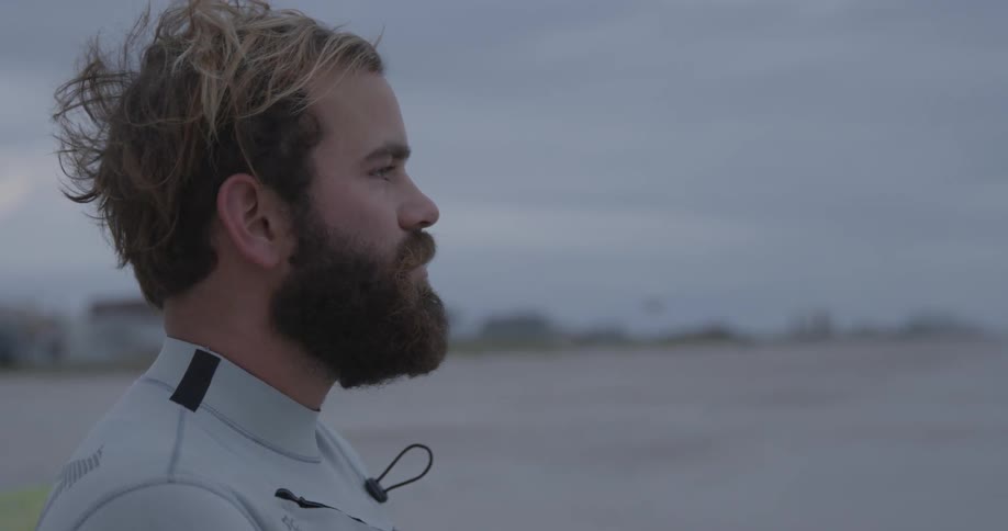 Man wearing a wet suit looks out