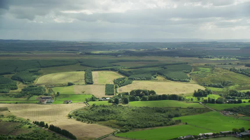 Aerial of a green grassland on a landscape in a rural area with a wide open horizon