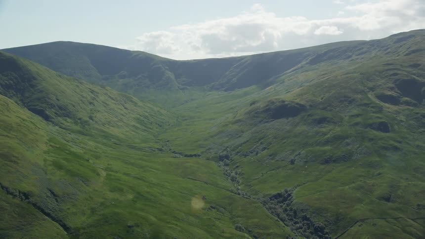 Aerial view of green vegetation on the slopes of a mountain range