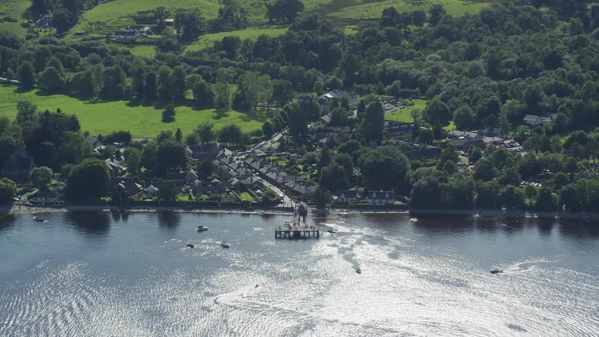 Aerial view of an urban city amidst fields and by the sea