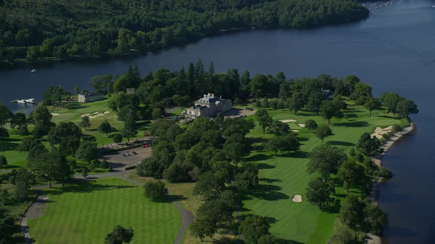 Aerial view of a public area with golf courses vegetation and by the seaside