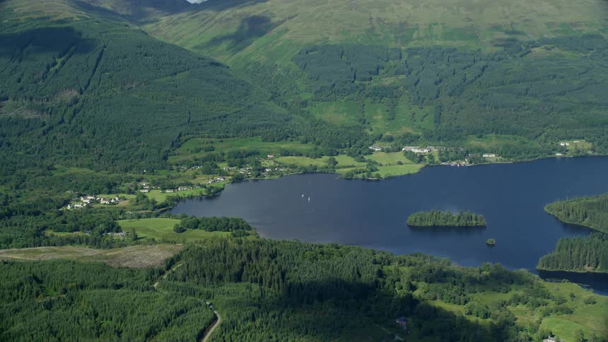 Aerial view of a mountain range vegetation and a central lake