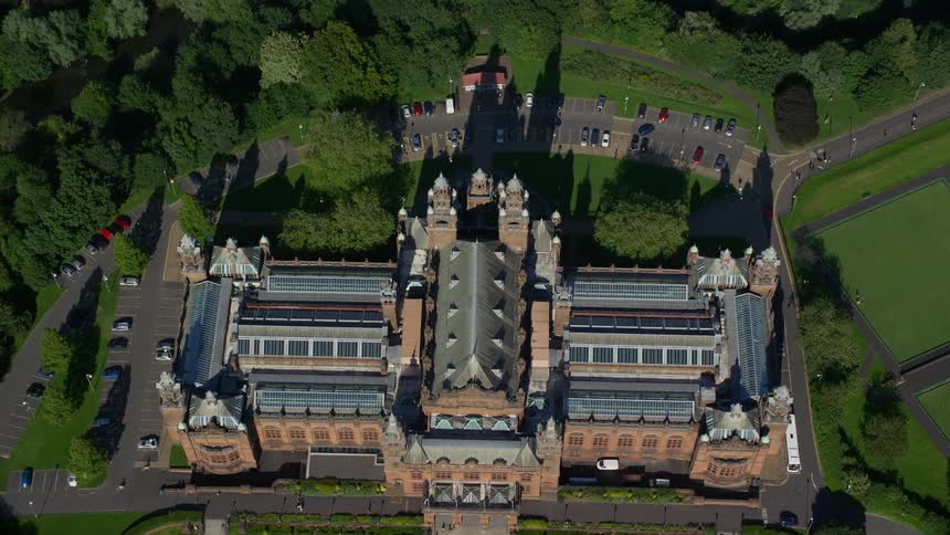 Aerial view of an impressive building with classical architecture surrounded by an outdoor area with vegetation